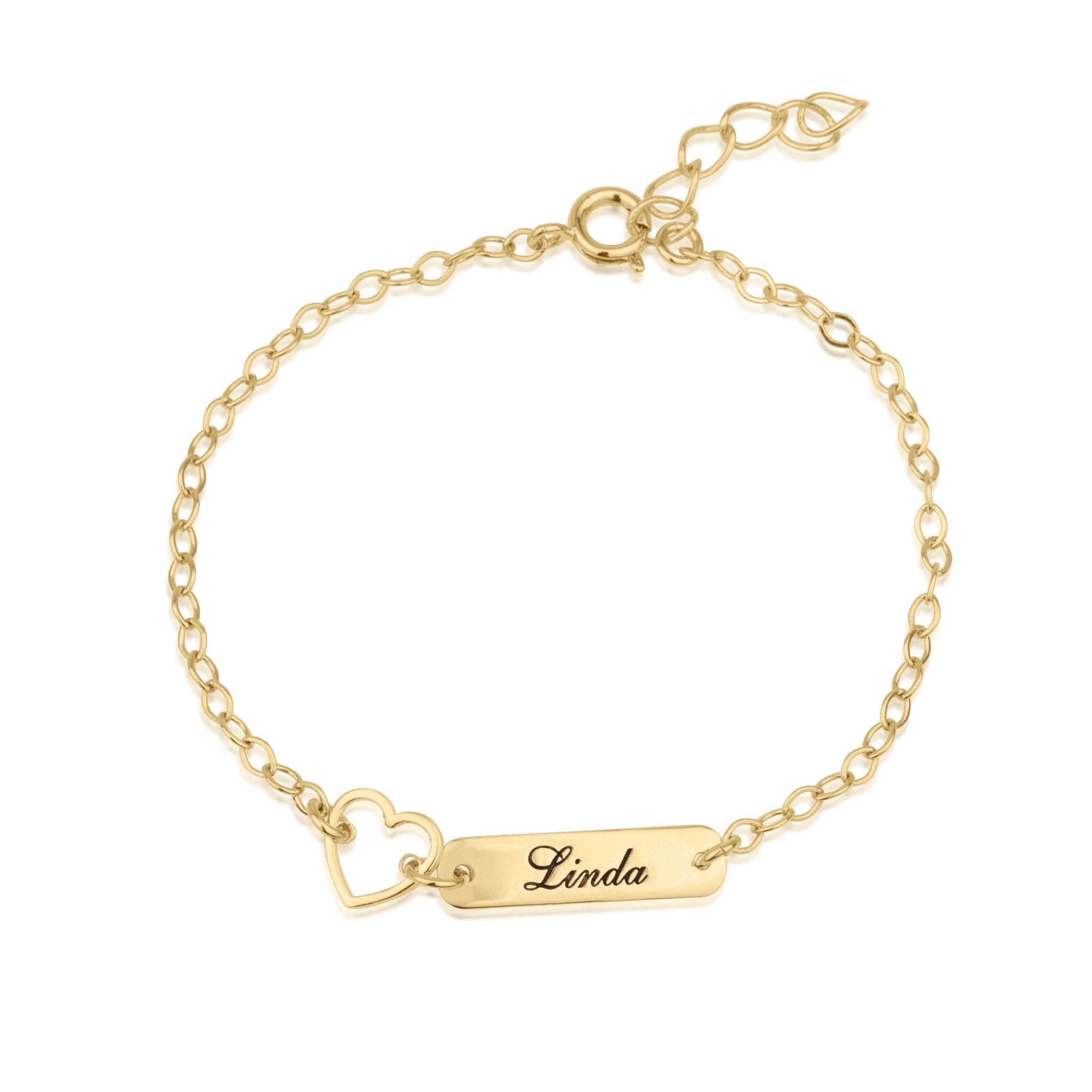 A gold chain bracelet with a rectangular bar engraved with the name 'Linda' and a small heart charm, shown on a plain white background.