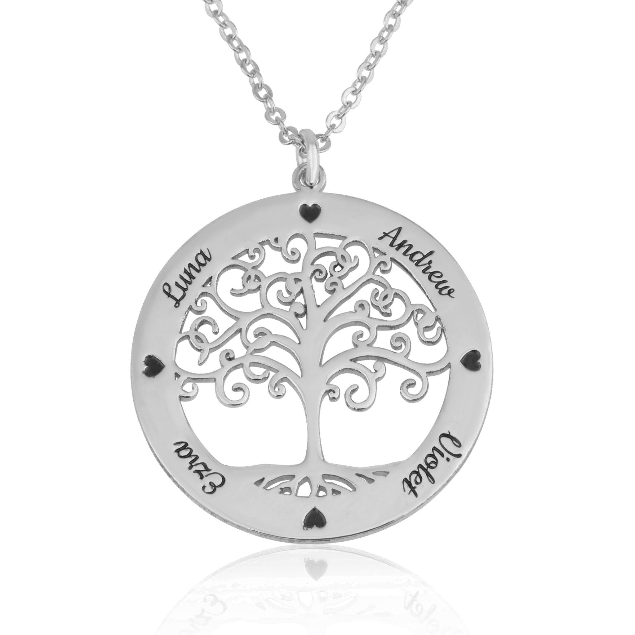 A silver personalized family tree pendant necklace on a matching chain, featuring a cutout tree design with names and heart accents engraved on a white background.